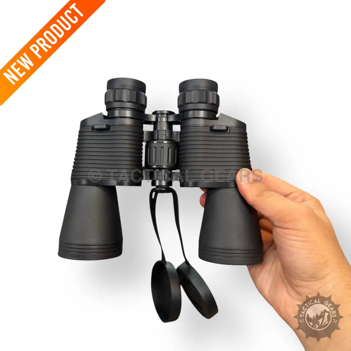 Black 20x50 sports binocular with ribbed grips and attached lens caps held by hand