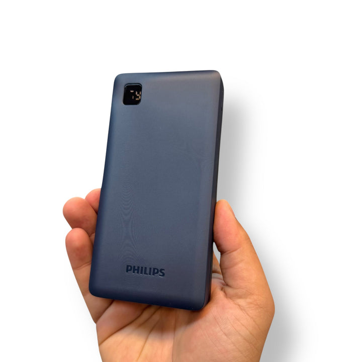 Dark blue feature phone with textured back and small screen held in hand, ideal for fast charging power banks