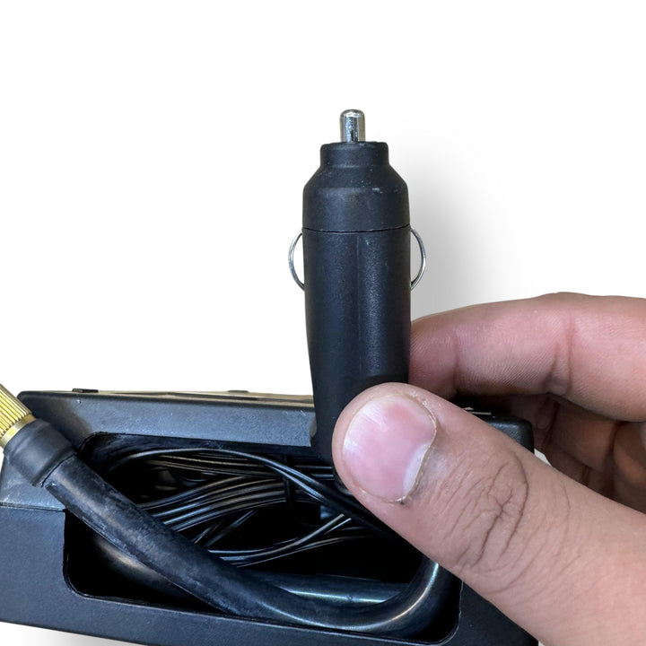 Original tire inflator with car adapter showing compact black tire inflator with cigarette lighter plug