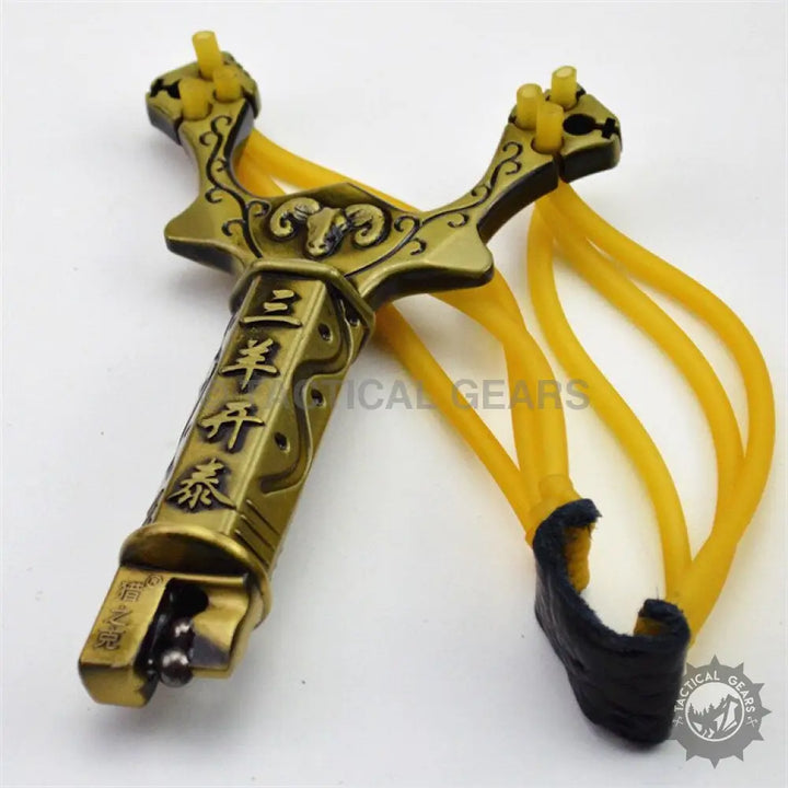 Ornate brass hunting slingshot with yellow rubber bands and black leather pouch