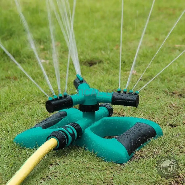 Green and black oscillating sprinkler with multiple water jets for even lawn watering