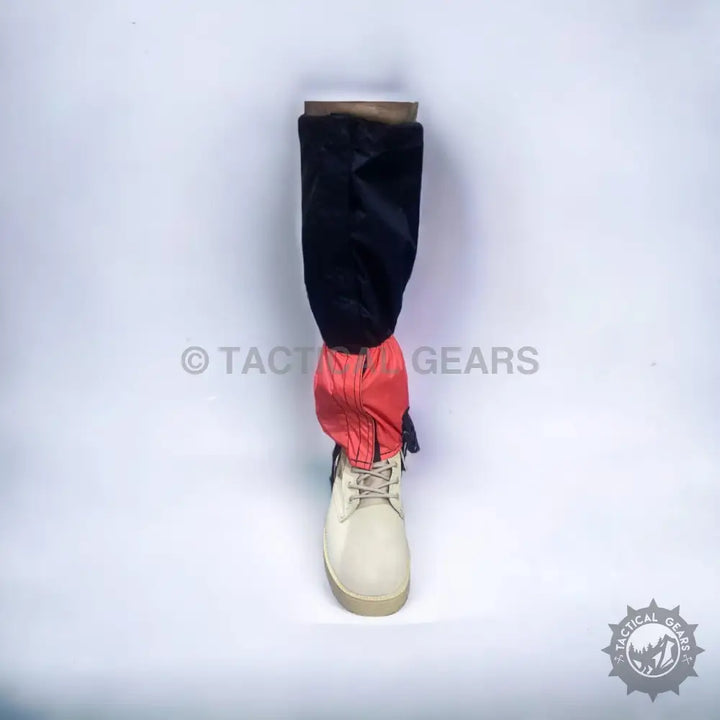 Black and red outdoor hiking gaiters over a light-colored boot for waterproof protection