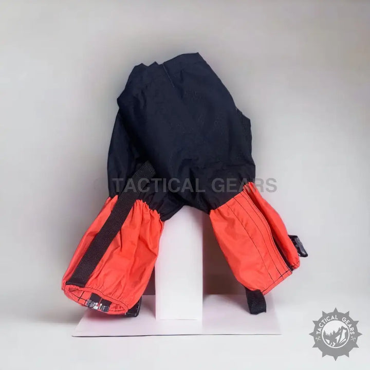 Black and orange outdoor hiking gaiters with elasticized cuffs for waterproof protection