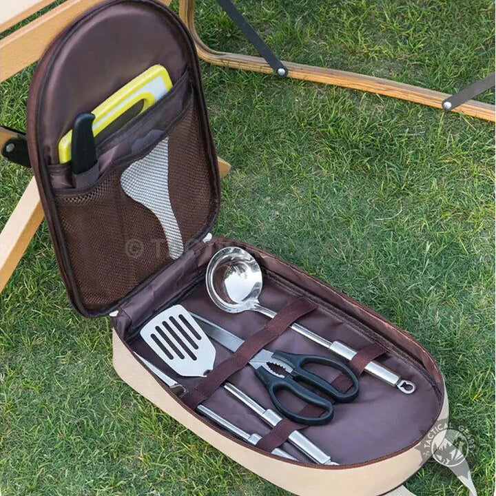 Outdoor portable camping kitchen utensil set in an open brown case for outdoor cooking
