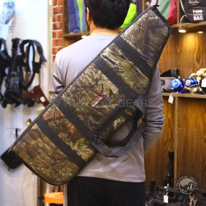 Camo rifle case with shoulder strap and carrying handle featuring zipper pouch for storage