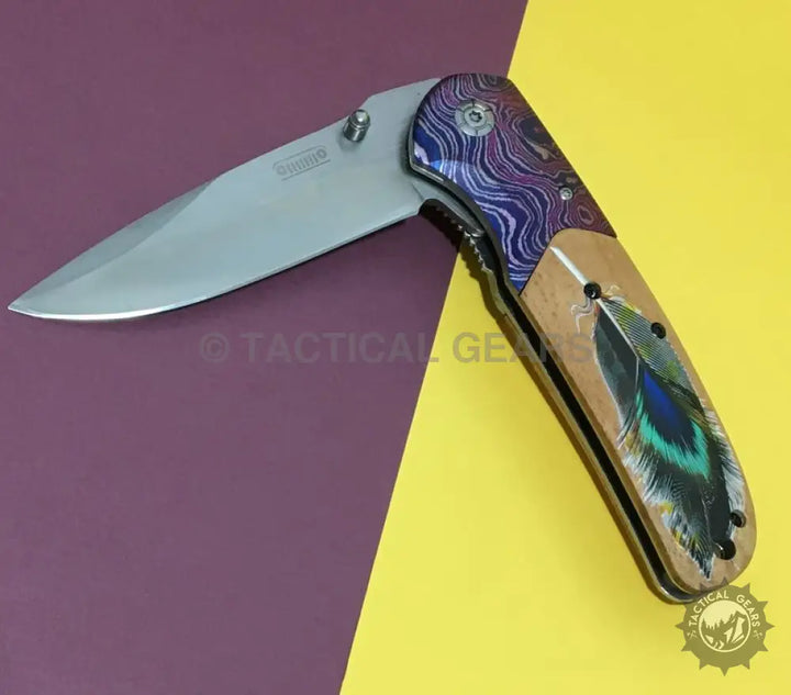 Jeep DA153 Tactical Survival Knife with gray blade, purple bolster, and colorful feather handle