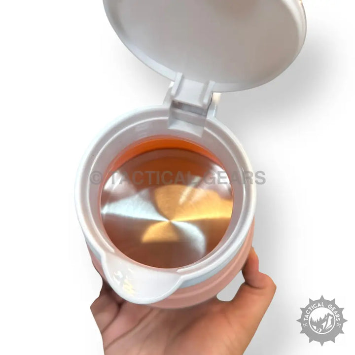 Pink 600ml Travelling Folding Kettle with open lid, orange interior, stainless steel heating element