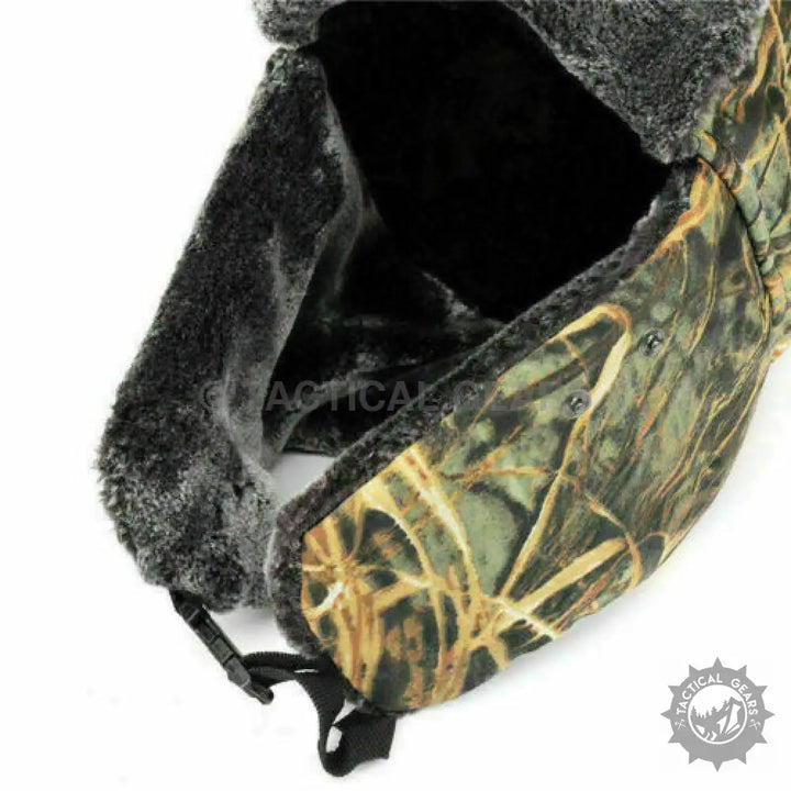 Camo trapper ski hat with dark faux fur lining and ear flaps for staying warm