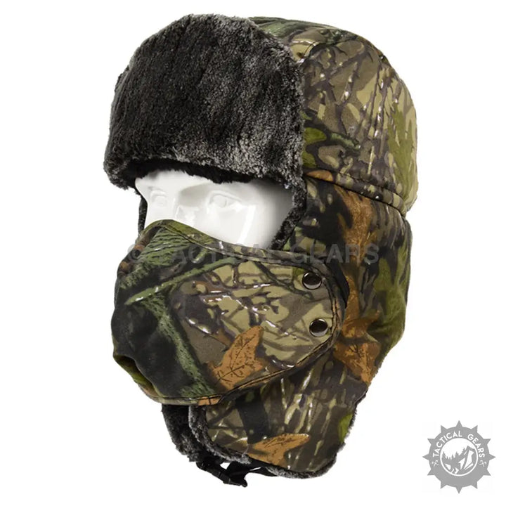 Camouflage trapper ski hat with black faux fur trim and attached face mask for staying warm