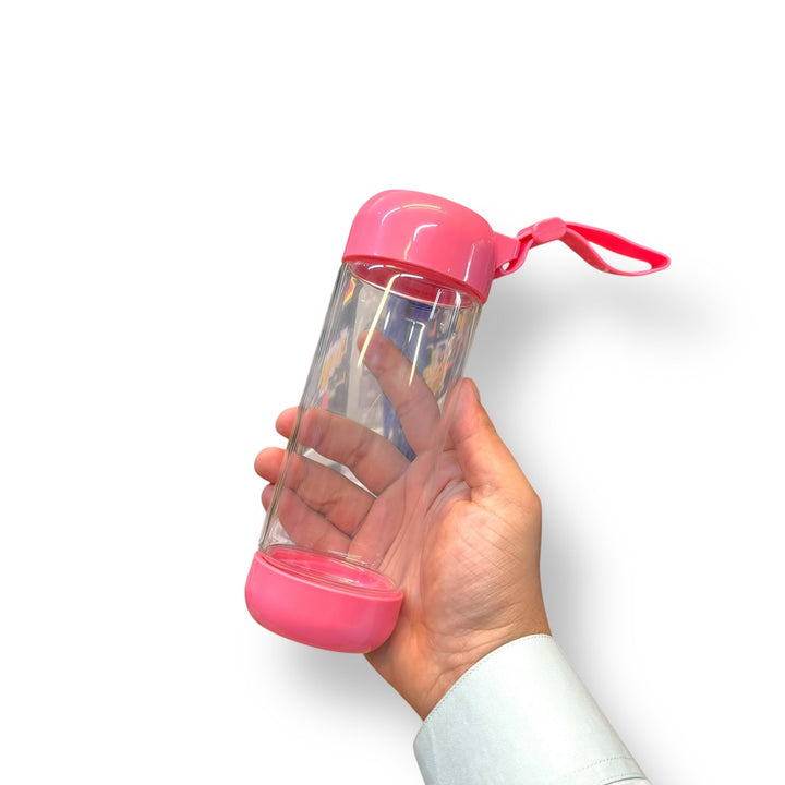 Portable 420ml Blender water bottle with pink lid held by hand