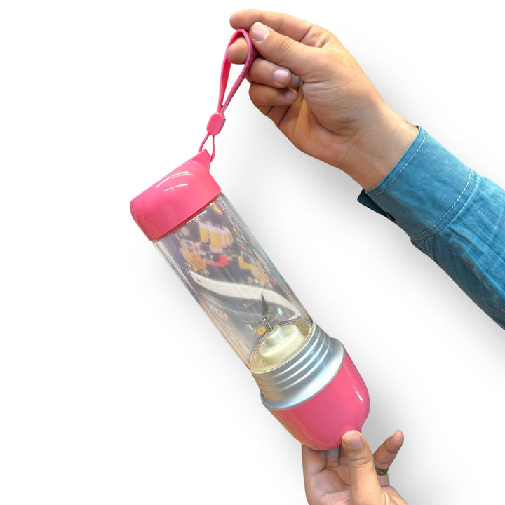 Pink portable 420ml blender with clear mixing chamber and carrying strap for on-the-go smoothies