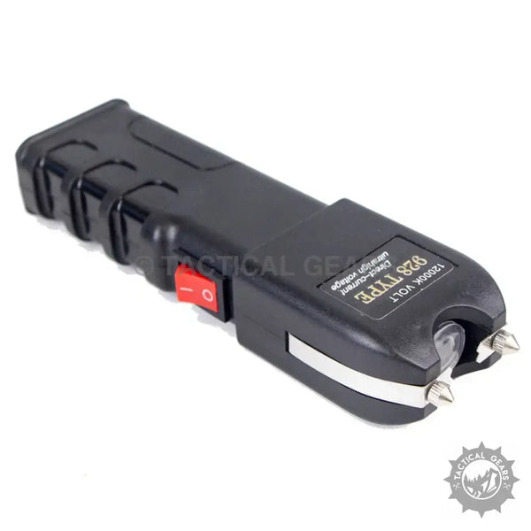 Black portable anti riot stun gun with red safety switch and sharp metal prongs