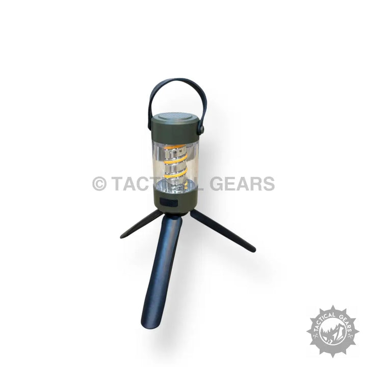 Portable camping light with built-in Bluetooth speaker, dark green top, clear body, retractable tripod