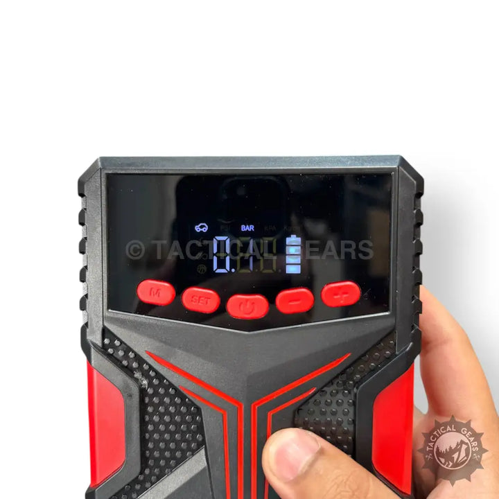 Portable car jump starter with air compressor, digital display, and control buttons
