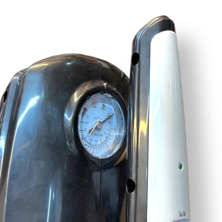 Black and white portable air compressor with pressure gauge for car vacuum cleaner use