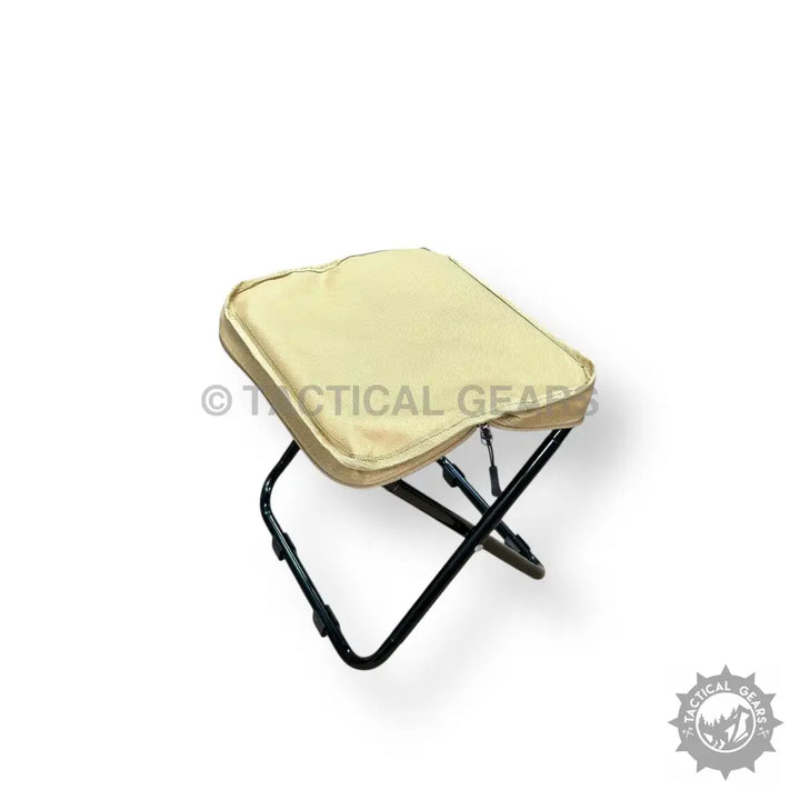 Portable folding camping stool with beige padded seat for outdoor adventures