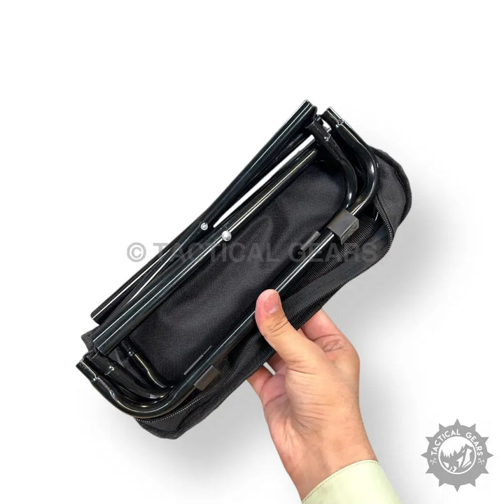 Black portable folding camping stool in its carrying case for easy transport