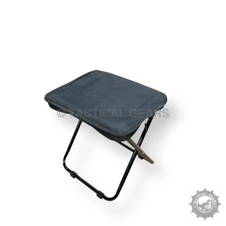 Portable folding camping stool with dark fabric seat for outdoor adventures