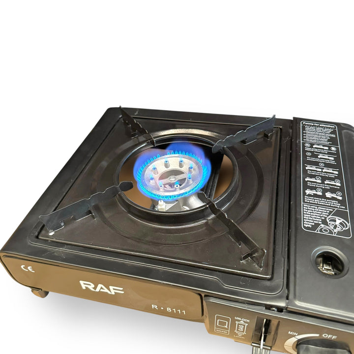 Black portable gas burner stove with blue flame, ideal for camping and outdoor use