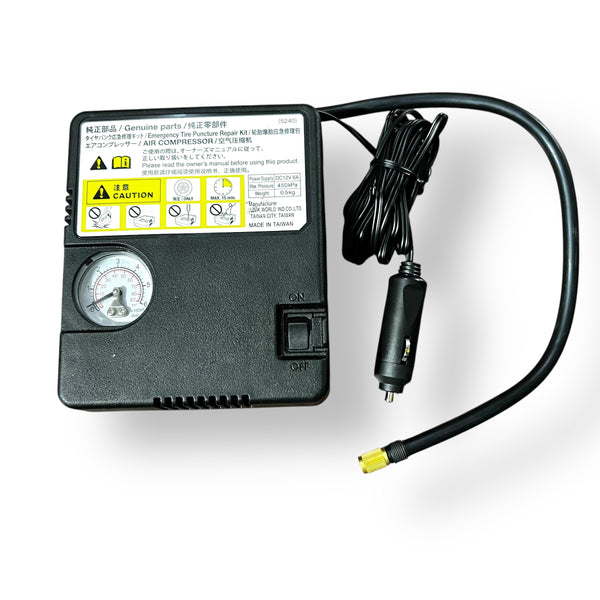 Black portable tyre inflator air compressor with pressure gauge and coiled power cord