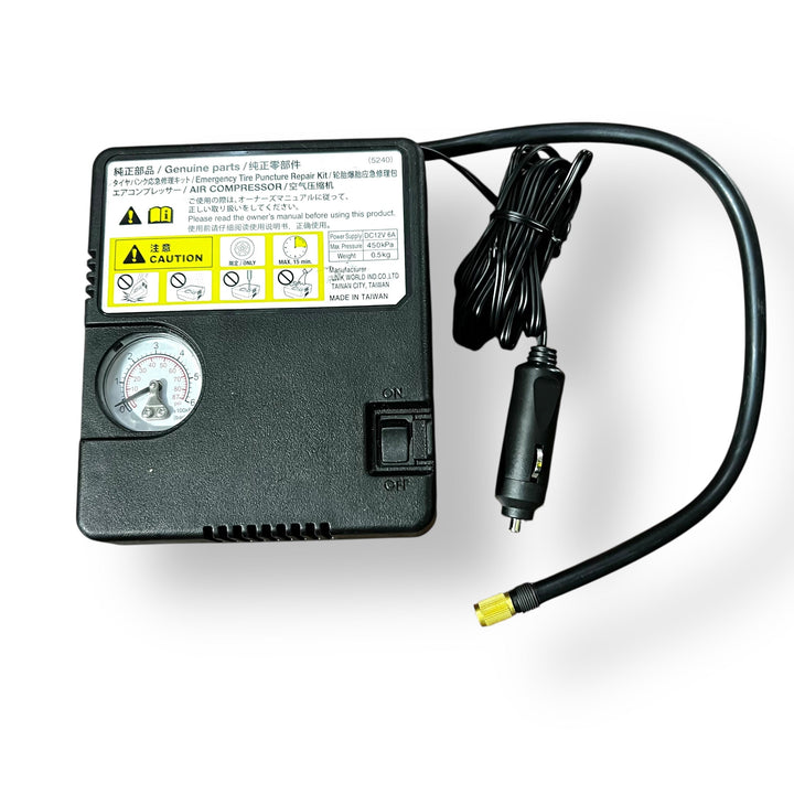 Black portable tyre inflator air compressor with pressure gauge and coiled power cord