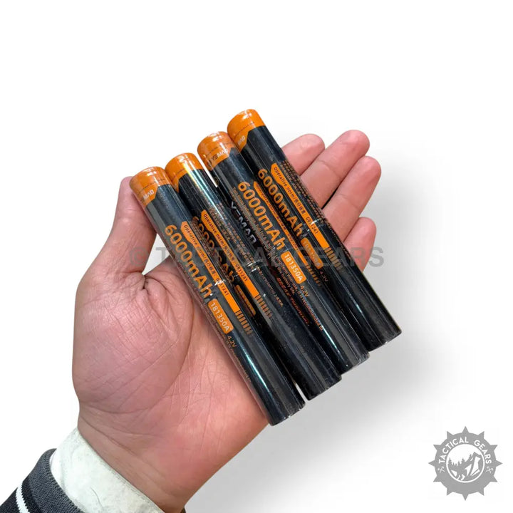 Hand holding five black and orange 6000mAh batteries for Powerful Tactical 3km LED Flashlights