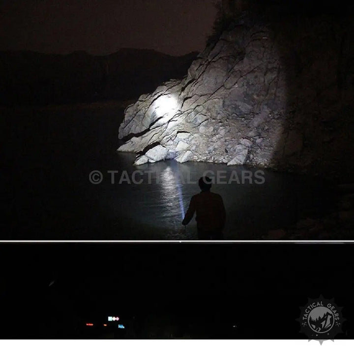 Person holding powerful tactical torch illuminating rocky shore at night with 1-km range