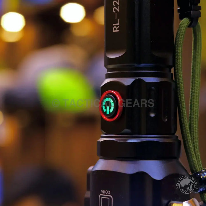 Black tactical flashlight with green power button and paracord lanyard for powerful tactical torch with 1-km range