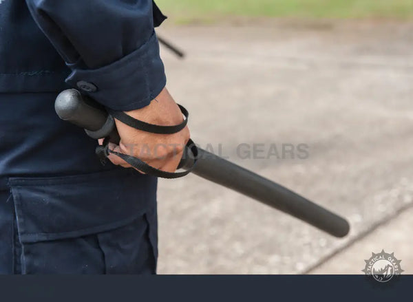 Person holding a polymer security baton with wrist strap for enhanced security and safety