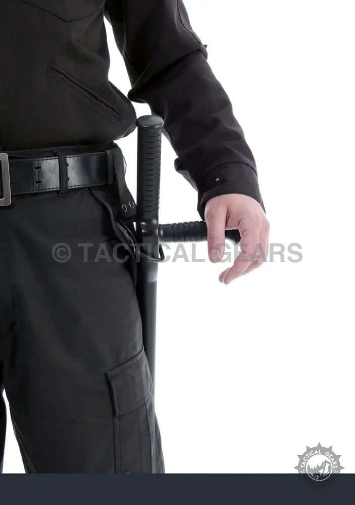 Person in black uniform holding a polymer security baton for riot control security