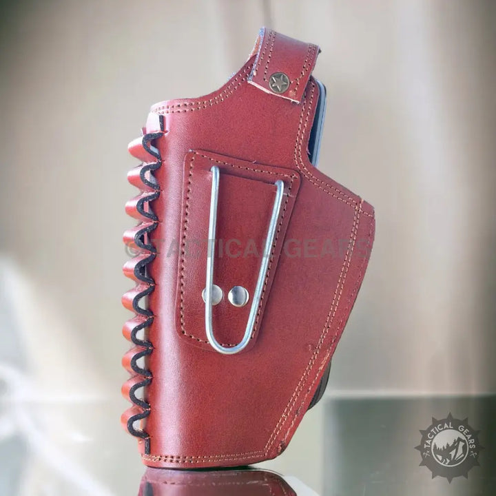 Red leather 9mm holster with ammunition loop and belt clip for carrying firearms