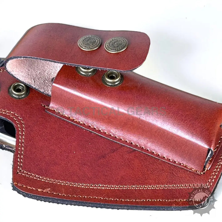 Reddish-brown leather 9mm holster with snap closures for comfortable carrying