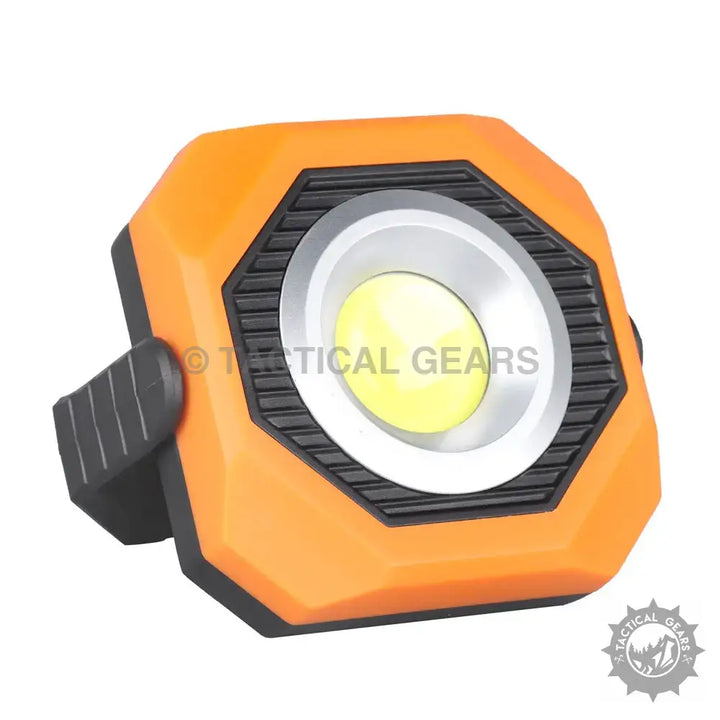 Orange octagonal COB LED work light with pivoting adjustment and magnetic solar base