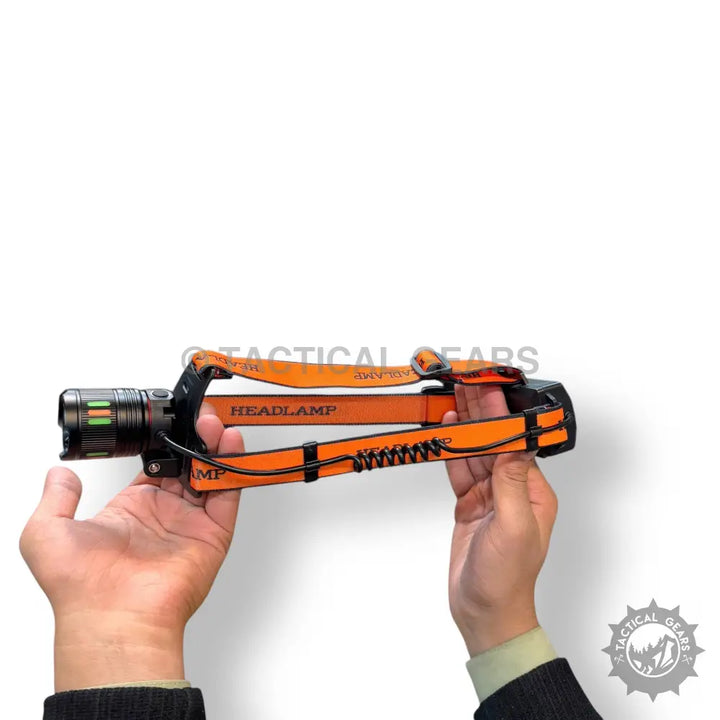 Rechargeable Headlight with orange headlamp and black flashlight on adjustable strap. Lot imported