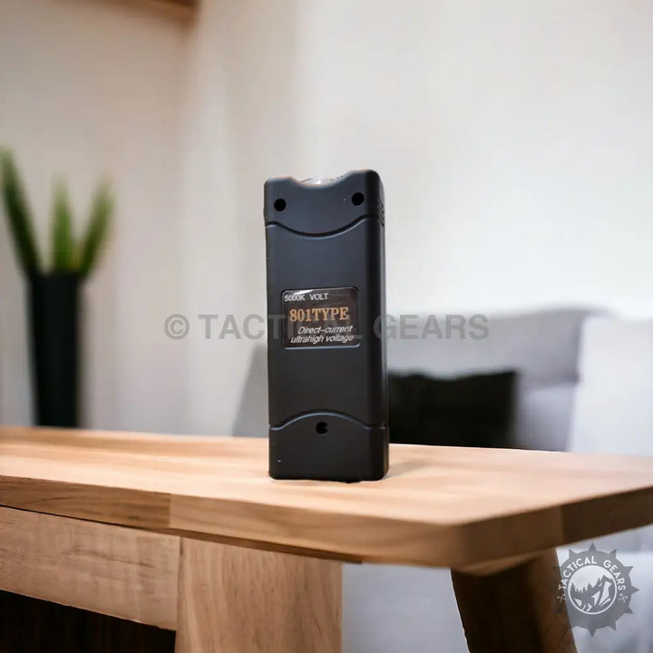 Black rectangular stun gun with curved sides, Tactical Pocket Taser for self-defense