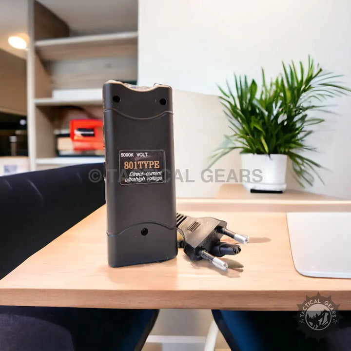 Black rectangular Tactical Pocket Taser stun gun with integrated charger for self-defense