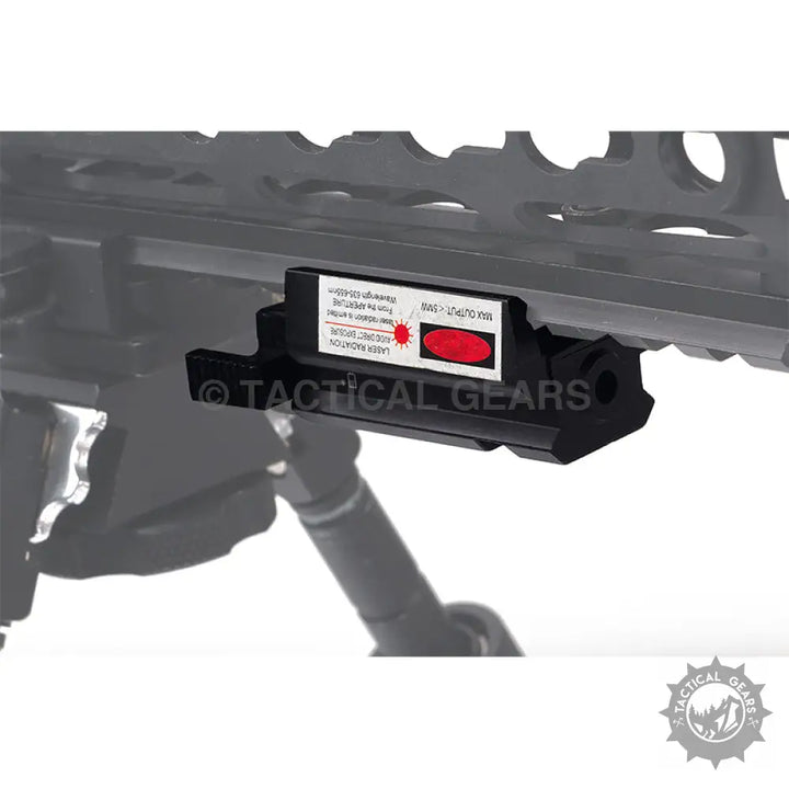 Black tactical laser sight with red dot laser mounted on rifle for precise aiming
