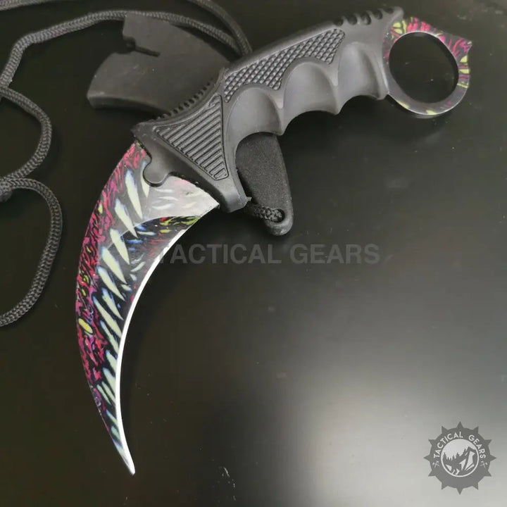 Black-handled pattern karambit knife with curved multi-colored blade for tactical use