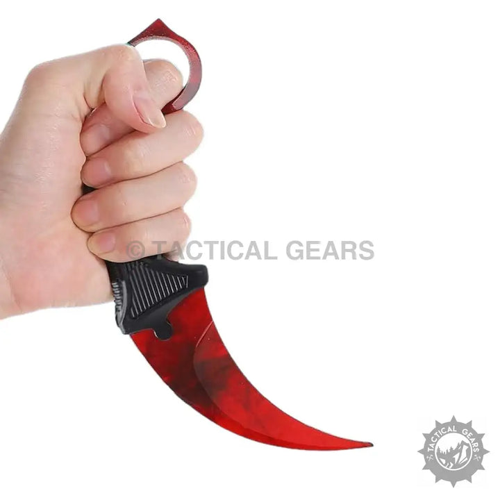 Hand holding a red and black pattern karambit knife from Spiderman Crack Pattern Karambit Knife collection
