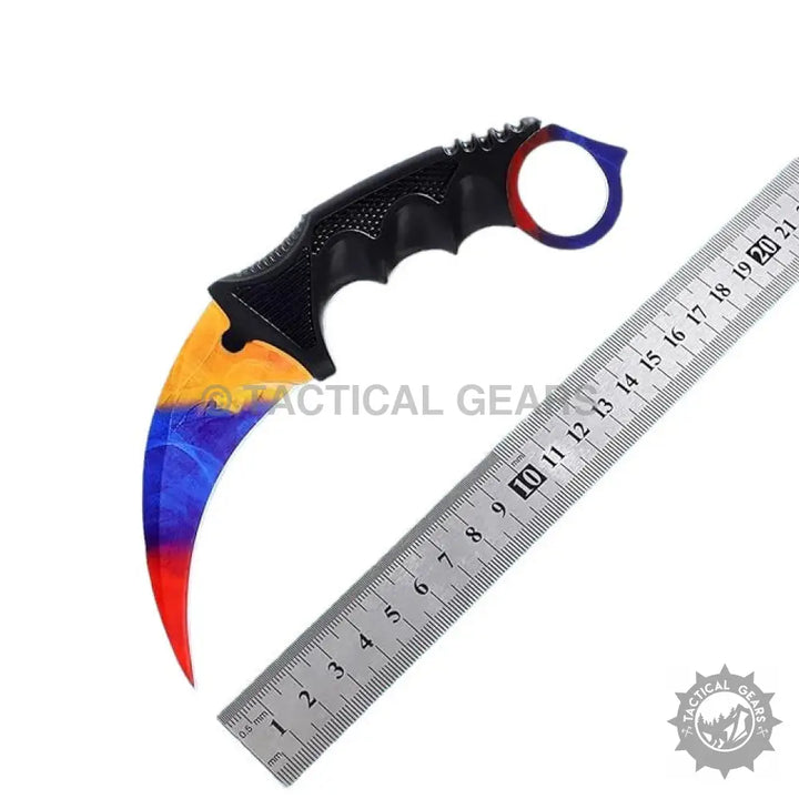 Pattern Karambit Knife with curved blade, colorful yellow, blue, red, black handle, and metal ruler
