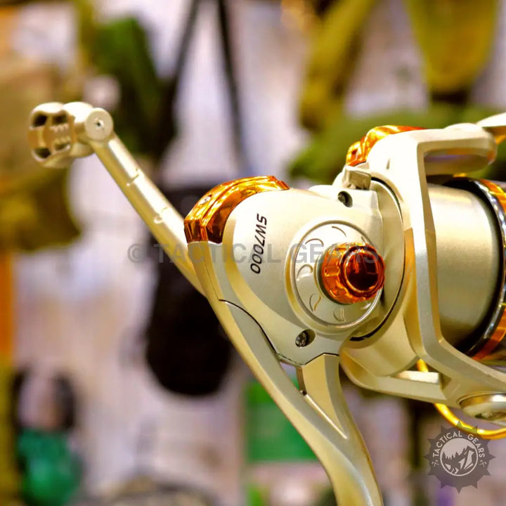 Golden fishing reel with handle and spool in Retractable Fishing Rod Set, part of fishing rod set