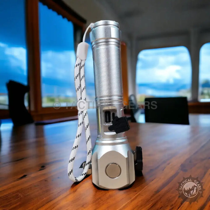 Silver metallic Ruilang Multifunctional LED Flashlight with ribbed body and striped wrist strap