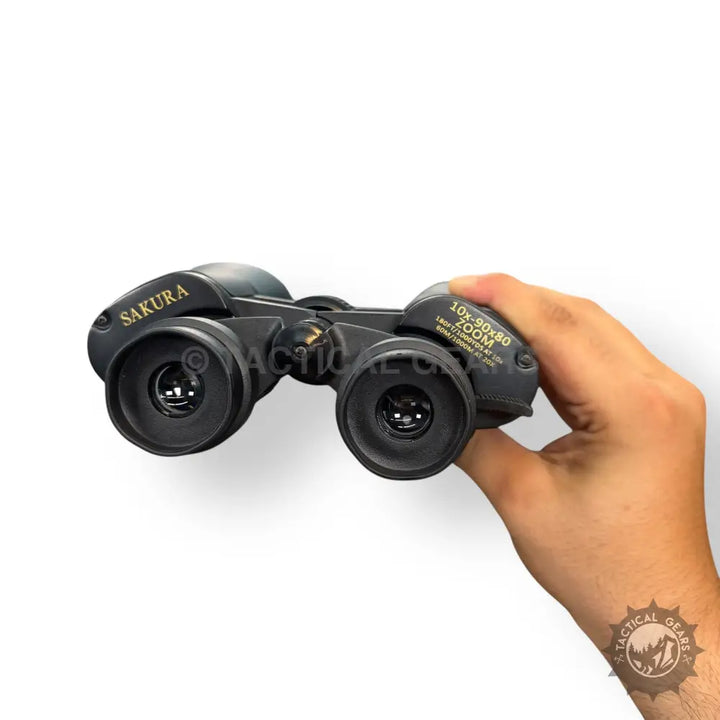 Black Sakura 90x80 Zooming Binoculars held in hand for clear distant viewing