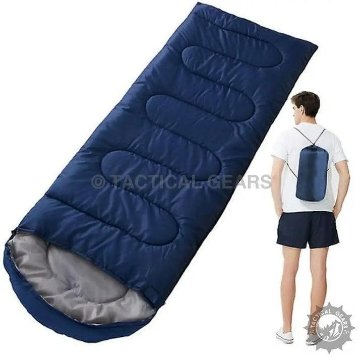 Dark blue sleeping bag with grey interior in compact drawstring bag for camping
