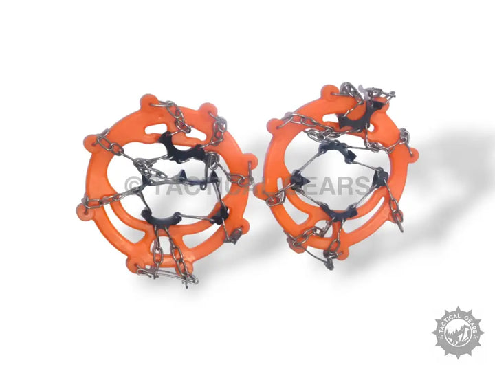 Orange snow grips crampons ice traction cleats with metal chains and spikes for winter safety