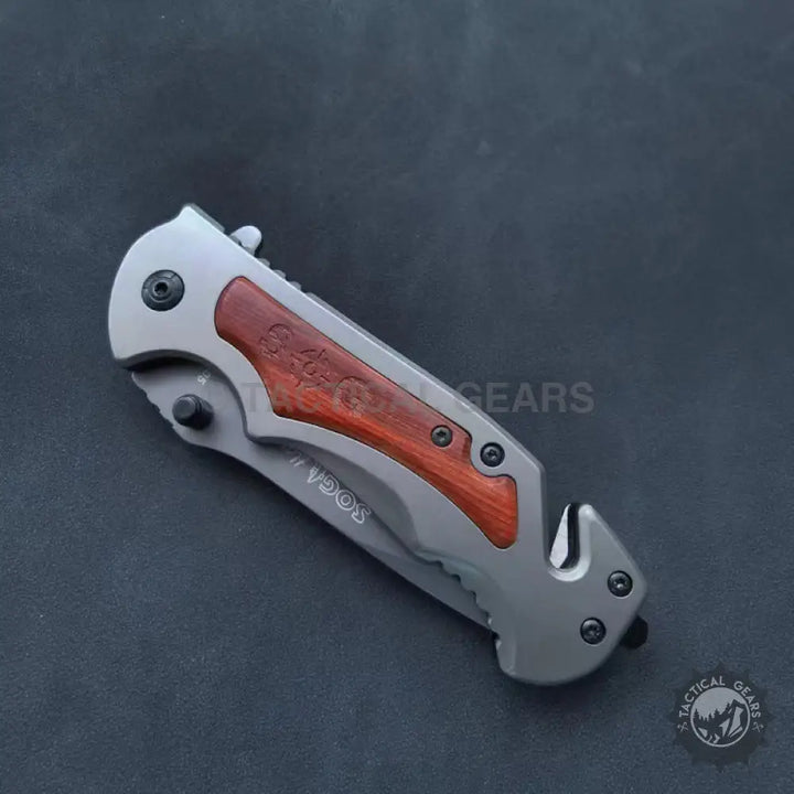 Gray metal SOG Tactical Folding Pocket Knife with dark wood handle accents