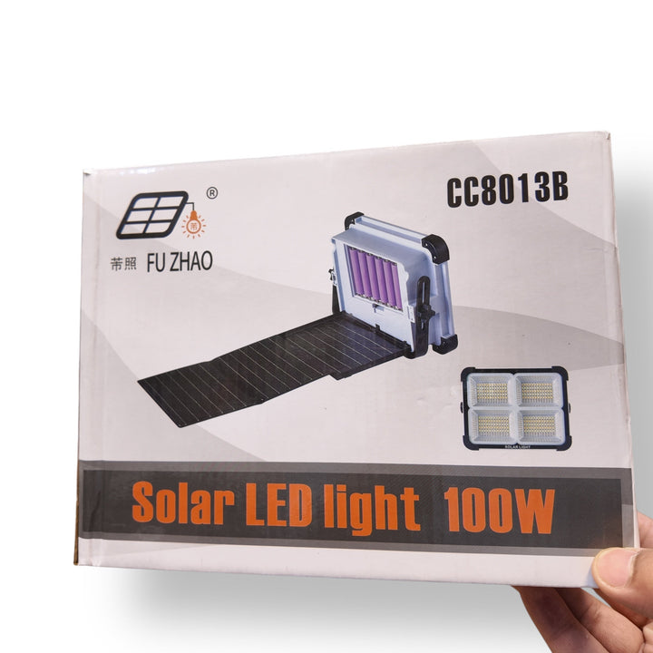 Solar 100W Flood Light in packaging with foldable solar panel for outdoor lighting