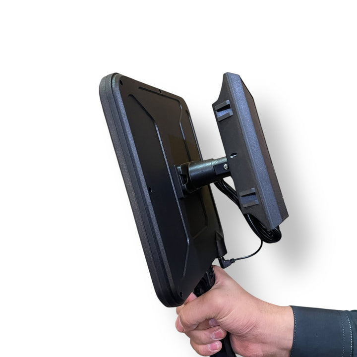 Person holding dual-screen portable device next to Solar Induction Street Lamp for professional use