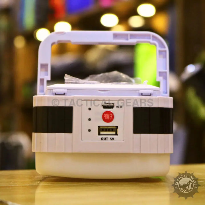 Portable solar powered camping lantern with charging indicator lights and USB output