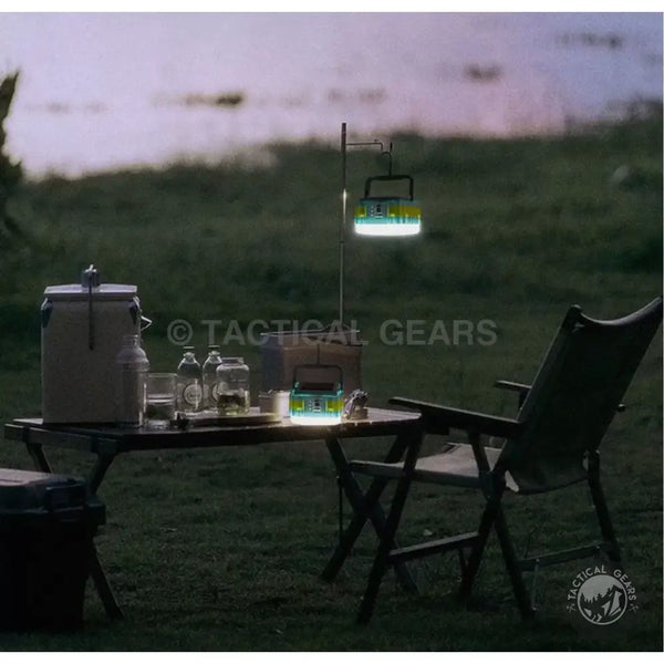 Portable camping table with chairs and solar powered camping lantern for outdoor adventures